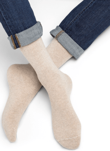 Model wearing Wool Cashmere Socks Mid Cordage by Bleuforêt, available at The Foundation, showing soft beige cashmere blend socks for warmth and comfort.