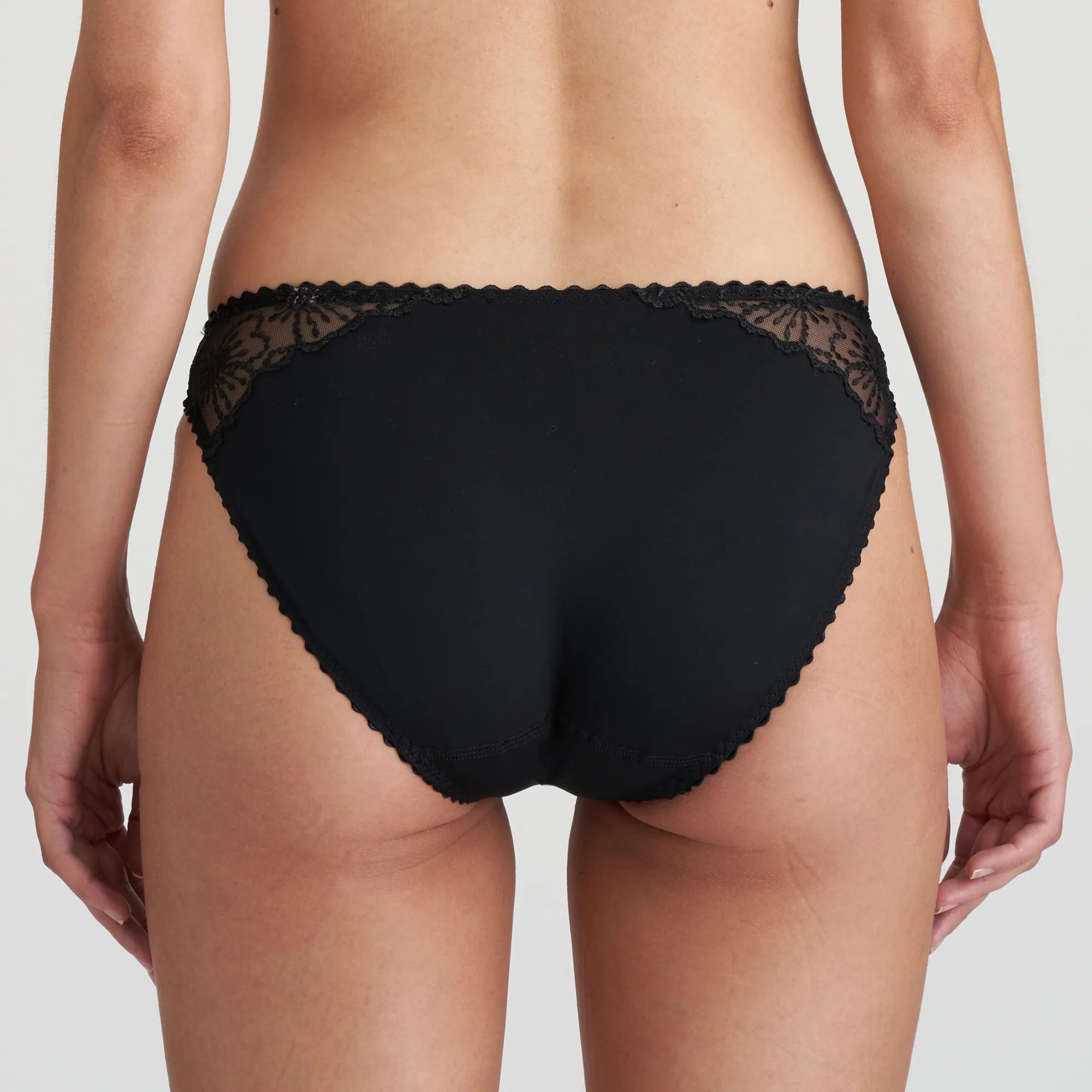 Back view of Jane Rio Brief Black highlighting smooth finish and flattering mid-rise fit.