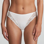 Model wearing Marie Jo Jane Italian Brief in Natural from The Foundation, featuring floral embroidery, sheer lace, and a small pearl-detailed back bow.
