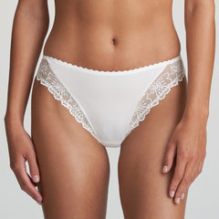 Model wearing Marie Jo Jane Italian Brief in Natural from The Foundation, featuring floral embroidery, sheer lace, and a small pearl-detailed back bow.