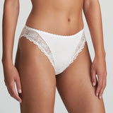 Model wearing Marie Jo Jane Italian Brief in Natural from The Foundation, featuring floral embroidery, sheer lace, and a small pearl-detailed back bow. side view