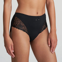 Model in Marie Jo Jane Full Brief in Black from The Foundation, featuring full coverage, sheer floral embroidery, and a front bow with pearl detail. side view
