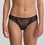 Model wearing Marie Jo Jane Thong Brief in Natural from The Foundation, with floral embroidery, sheer lace, and pearl-detailed bows at the back. front view