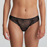 Model wearing Marie Jo Jane Thong Brief in Natural from The Foundation, with floral embroidery, sheer lace, and pearl-detailed bows at the back. front view