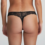 Model wearing Marie Jo Jane Thong Brief in Natural from The Foundation, with floral embroidery, sheer lace, and pearl-detailed bows at the back. back view