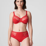 Model wearing PrimaDonna Deauville Full Brief in Scarlet from The Foundation, featuring high waist fit, smoothing support, and lace detail at the hips. front view