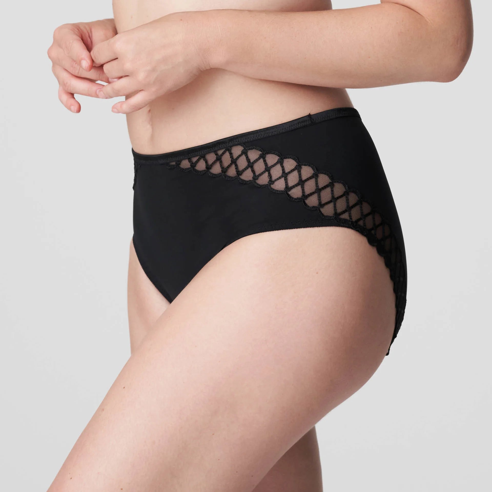 Side angle PrimaDonna Vya Full Brief in Black, featuring hip embroidery and high-cut leg opening with soft stretch mesh.