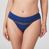 Front view of PrimaDonna Sophora Thong Royal in navy blue with sheer embroidered front, styled on model.