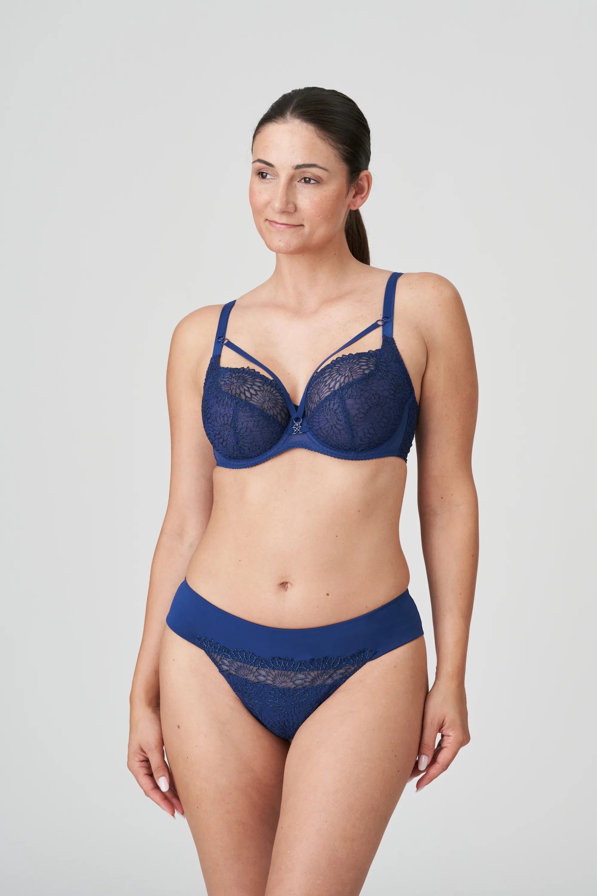 PrimaDonna Sophora Thong Royal styled with matching bra set in rich navy, featuring sheer glittering embroidery – exclusive to The Foundation.