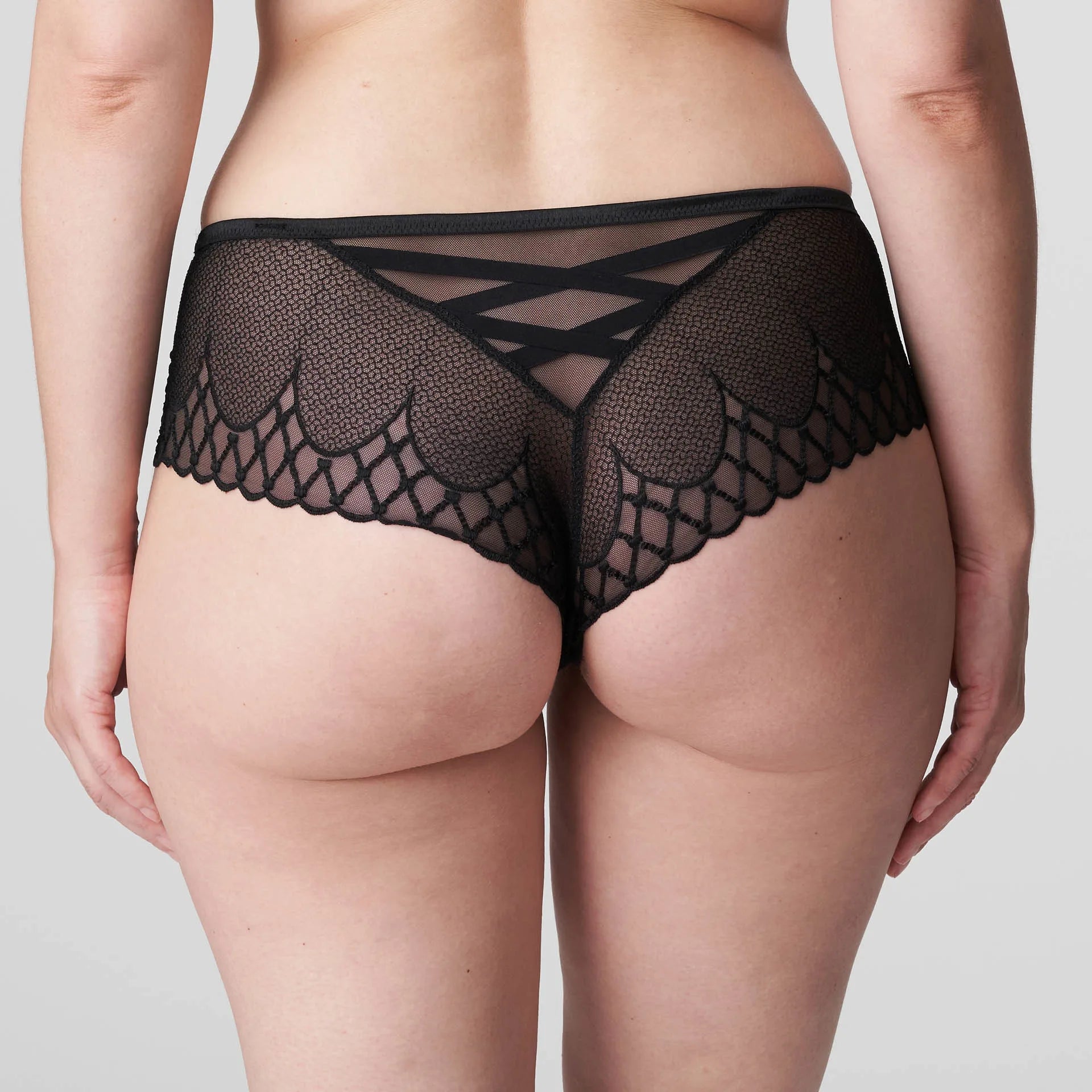 Back view of the Vya Thong in Black, featuring bold embroidery and sheer panels for a seductive finish.