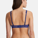 Model wearing Marie Jo Jane Padded Heart Shape Bra in Lazurite Blue from The Foundation, with embroidered cups, plunge neckline, and convertible straps. back view