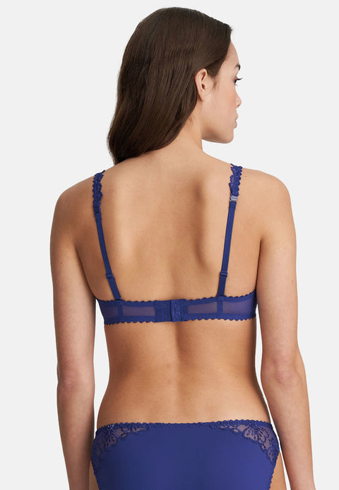 Model wearing Marie Jo Jane Padded Heart Shape Bra in Lazurite Blue from The Foundation, with embroidered cups, plunge neckline, and convertible straps. back view