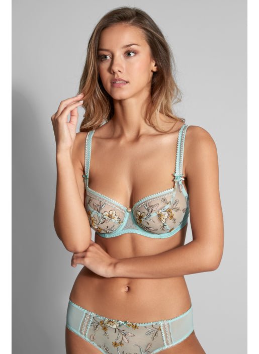 Model wearing Lauren Underwire Low Necked Bra in Turquoise, styled with embroidered detail – available at The Foundation.