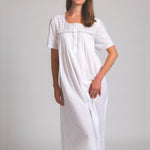 Model wearing Short Sleeve Square Yoke Nightie in white, featuring lace-trimmed square yoke and soft cotton voile fabric for airy comfort.