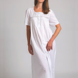 Model wearing Short Sleeve Square Yoke Nightie in white, featuring lace-trimmed square yoke and soft cotton voile fabric for airy comfort.