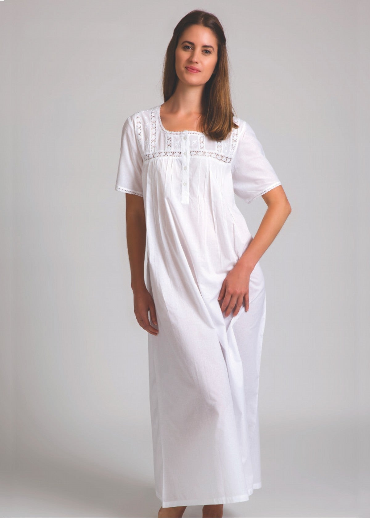 Model wearing Short Sleeve Square Yoke Nightie in white, featuring lace-trimmed square yoke and soft cotton voile fabric for airy comfort.