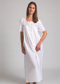 Model wearing Short Sleeve Square Yoke Nightie in white, featuring lace-trimmed square yoke and soft cotton voile fabric for airy comfort.