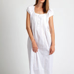 Model wearing Cap Sleeve Cotton Front Button Nightie in white, featuring pintuck detailing, ladder lace hem, and a button-down front.