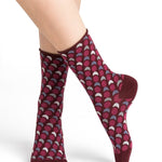 Model wearing Cotton Optical Dots Socks Mid Chianti by Bleuforêt, available at The Foundation, featuring red geometric dot patterned socks for women.
