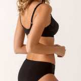 Side view of model in black Empreinte Lilly Rose brief, showing soft waistband and luxurious lace textures.