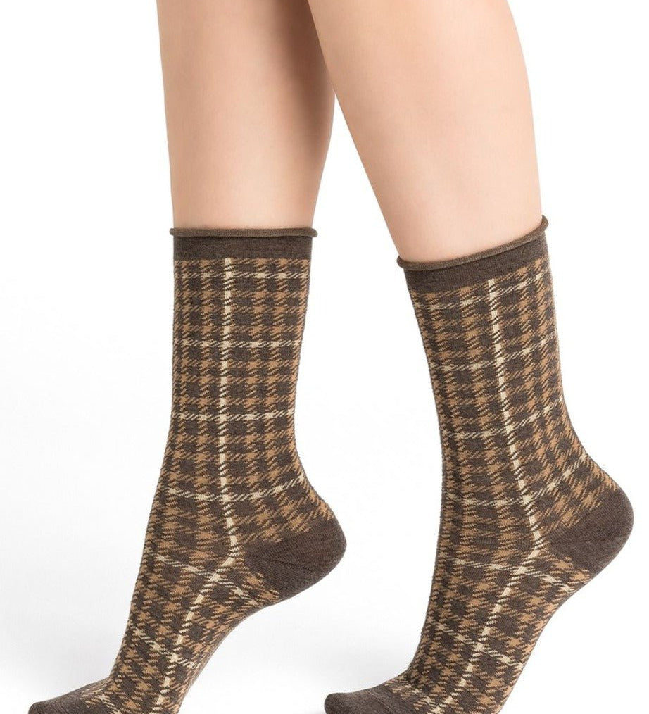 Model wearing Wool Blend Check Socks Mid Marmot by Bleuforêt, available at The Foundation, showing brown check patterned merino wool blend socks for women.