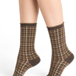 Model wearing Wool Blend Check Socks Mid Marmot by Bleuforêt, available at The Foundation, showing brown check patterned merino wool blend socks for women.